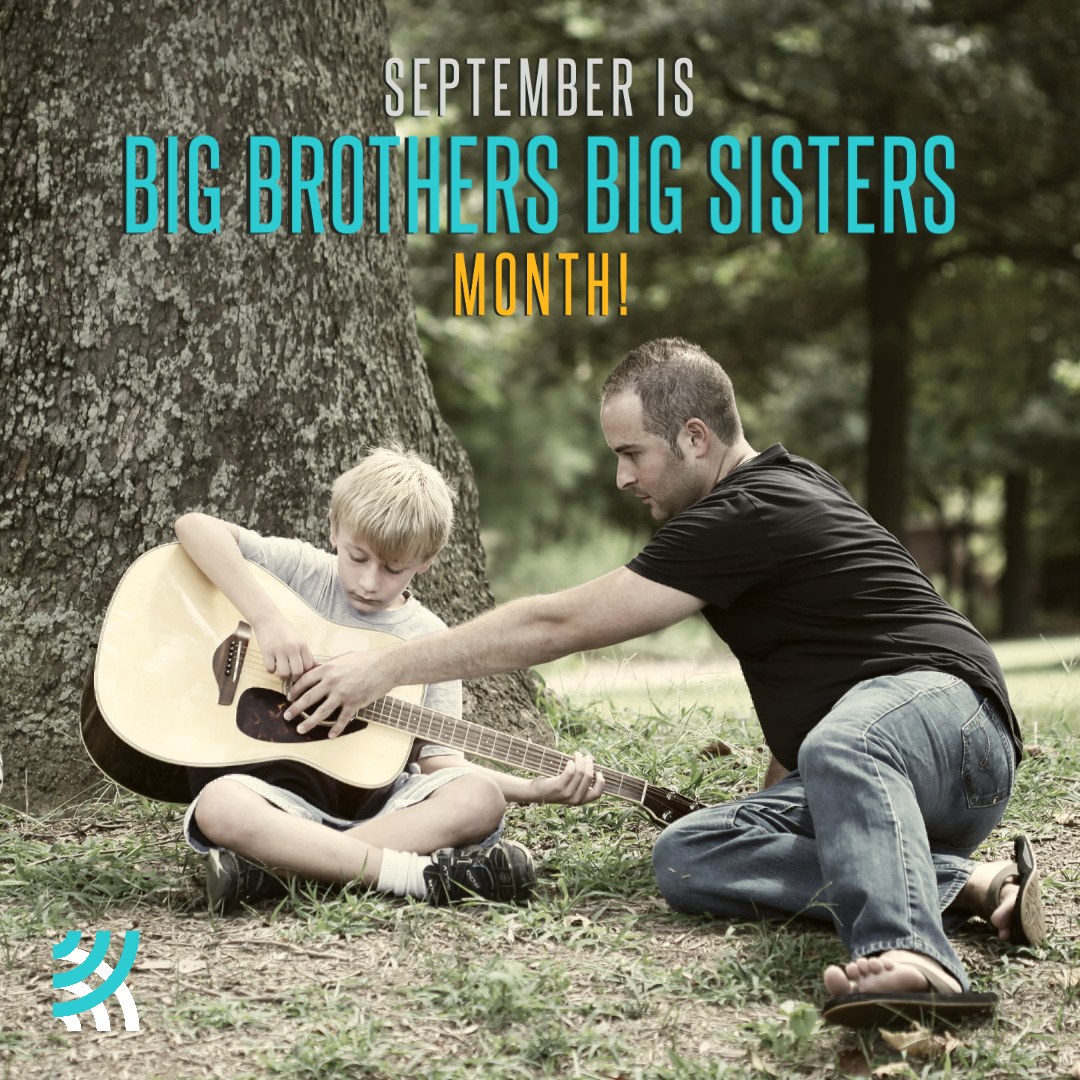 Photo of a man teaching a youth to play guitar while sitting under a tree. Text reads 'September is Big Brothers Big Sisters Month'