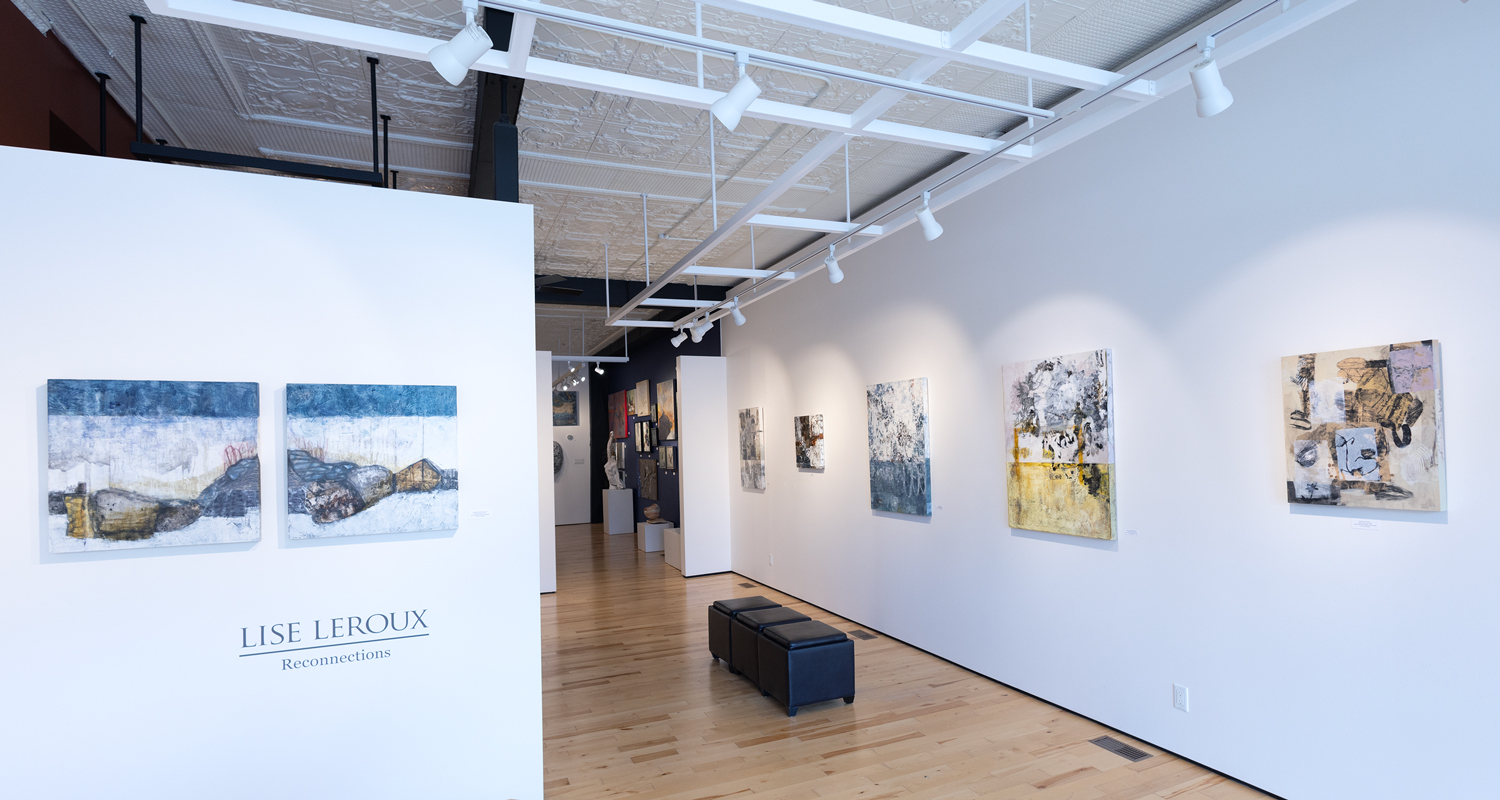 Artwork displayed on white walls inside a gallery