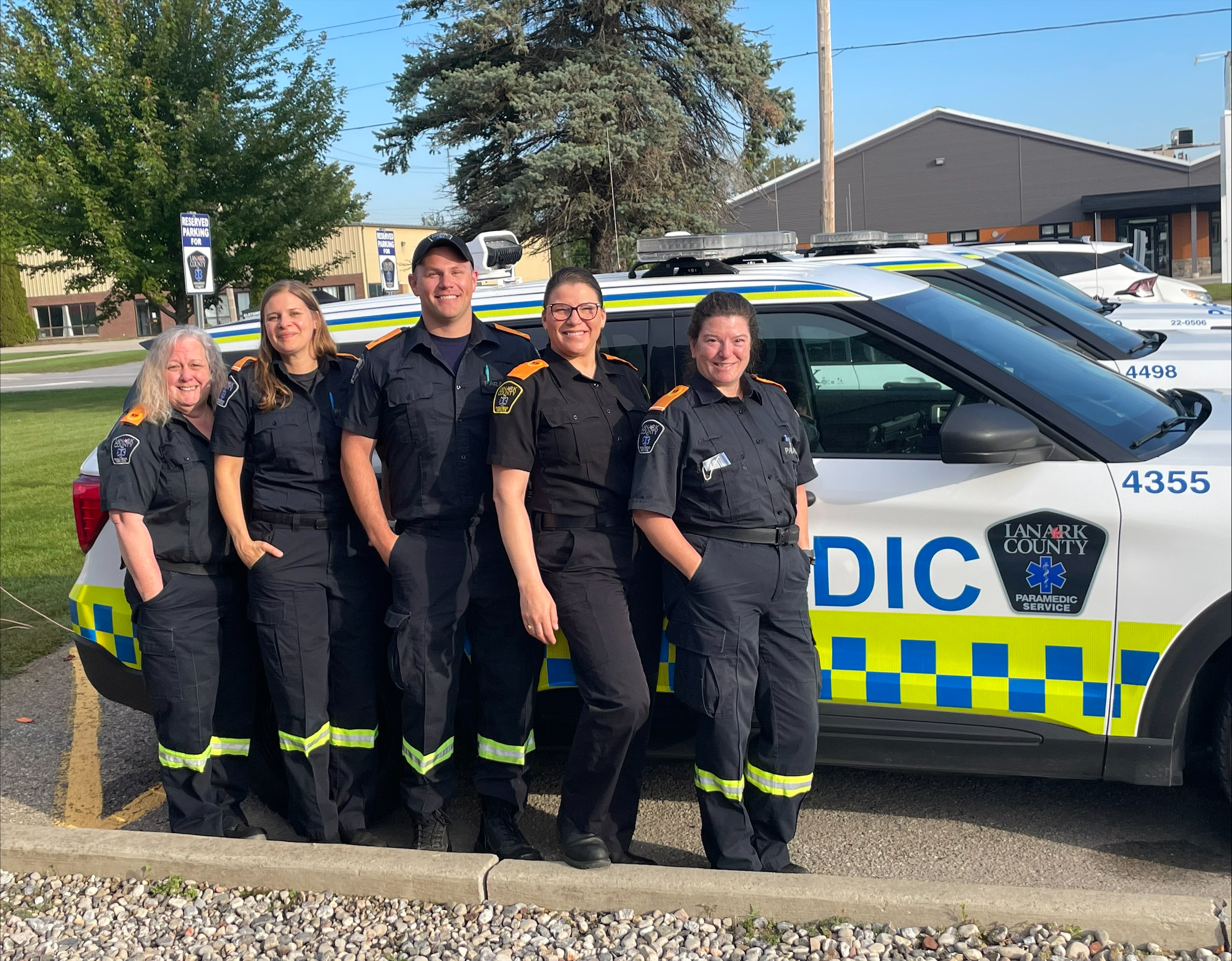 OPP officers in uniform standing in front of a police cruiser